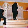Groom and officiant walking up onto stage for this Pacific Crest Grand Ballroom wedding in Oregon City. Ceremony and Photography by The Radiant Touch Weddings. officiant minister celebrant