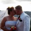 orange and yellow flowers at wedding. Bride's veil blowing in the wind.