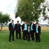 groom and groomsmen in black tuxedo with teal blue vest and tie