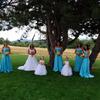 bridesmaids in teal blue dresses, flower girls in white dresses. Yellow and orange flowers