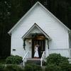 bride and groom on stairs of historic church