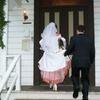 short veil and orange trimmed wedding gown