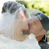 Bride and groom kissing on Harley Davidson motorcycle