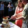 cutting the cake at a Beaverton / Aloha backyard wedding ceremony by The Radiant Touch